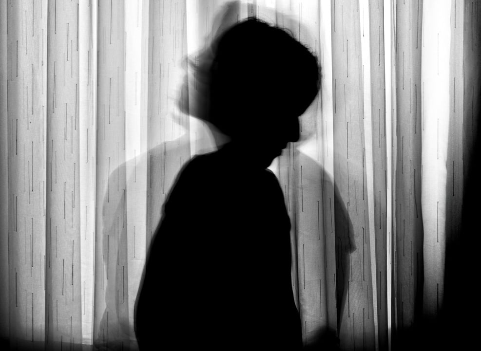 Silhouette of Person Standing Near Window Curtain